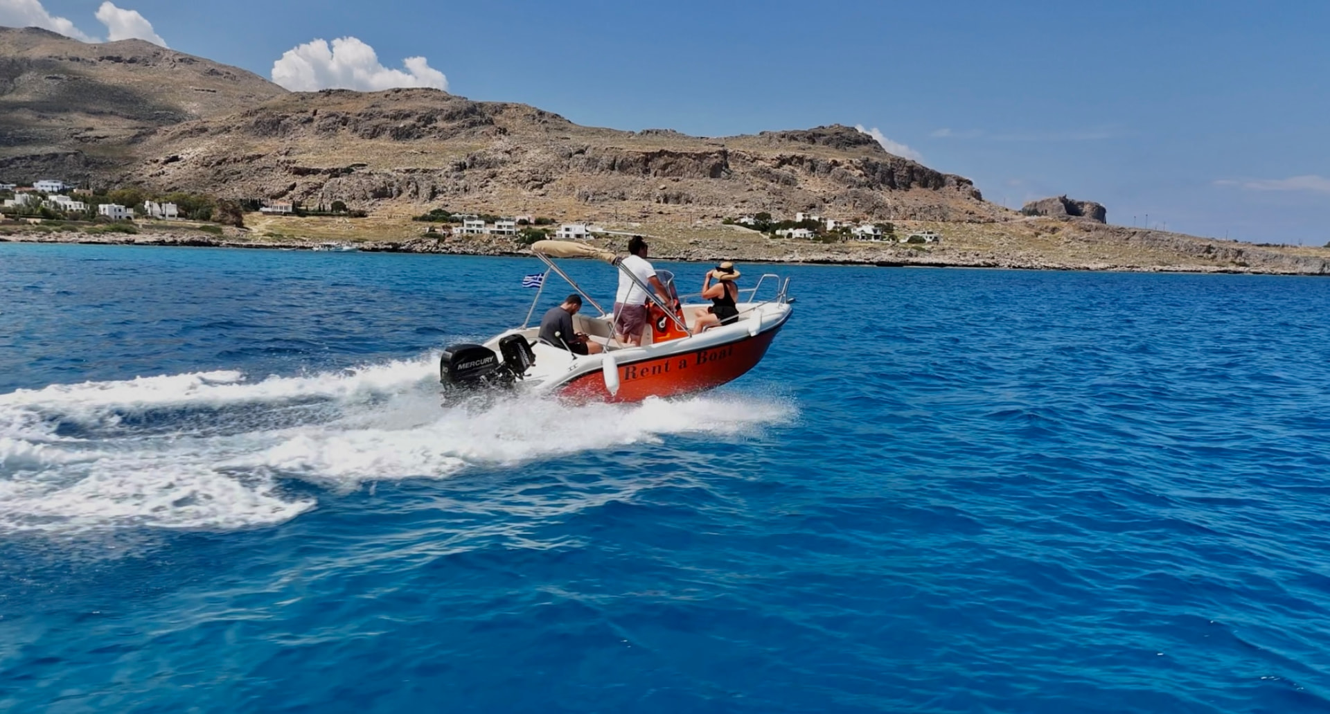 Guests speeding along the Rhodes coastline on a RÉMA rental boat
